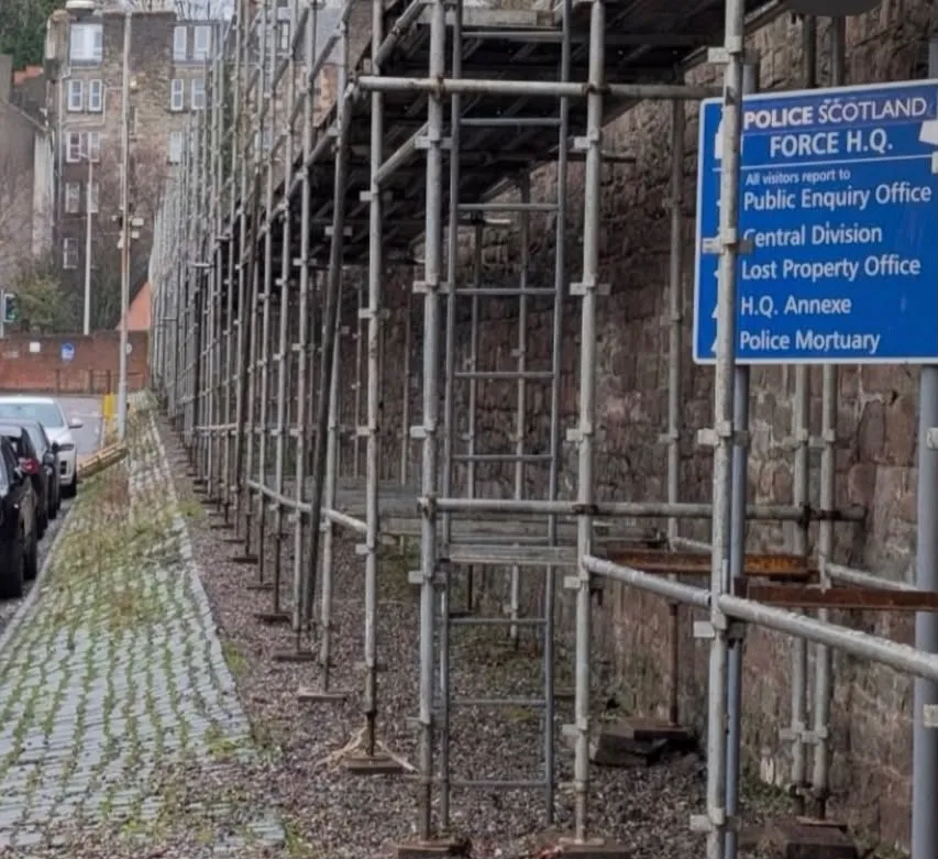 Scaffolding along the facade of a stone building